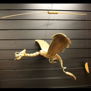 This crafty wholesale Large Natural Coconut Dragon Mobile will make a brilliant addition to your store.Made in Indonesia this beautiful dragon mobile has approximately a wingspan 46 cm and length 40 cm and hang 40 cm down off their hook.Just hang this beautiful flying dragon indoor or out... preferably in your garden and watch it fly around.  Order today and watch them fly out of your store.