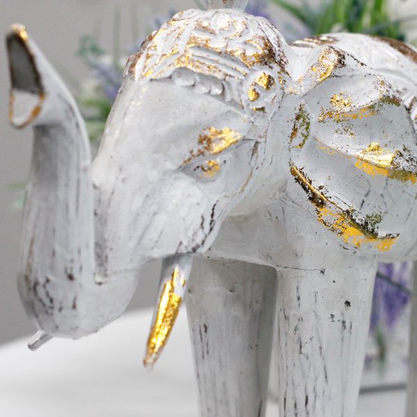 stature and strength. These Wholesale Elephants have been lightly painted in white and turquoise colours and added a golden glitter to it. These beautiful Hand Carved Elephant will bring an old world feeling of Bali into any room. Hand carved in Indonesia from Albesia wood