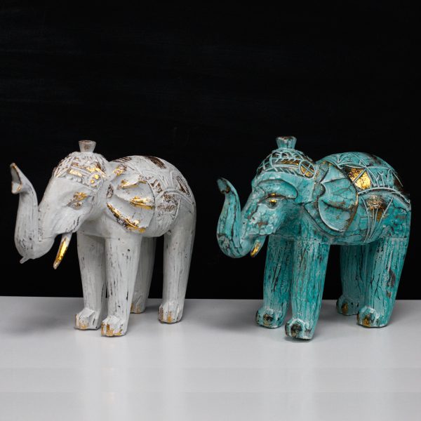stature and strength. These Wholesale Elephants have been lightly painted in white and turquoise colours and added a golden glitter to it. These beautiful Hand Carved Elephant will bring an old world feeling of Bali into any room. Hand carved in Indonesia from Albesia wood