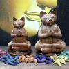 light the tip of the cone with a match or lighter and place our Wooden Yoga Cat on top of it. The smoke will find the way out through the cats' paws.